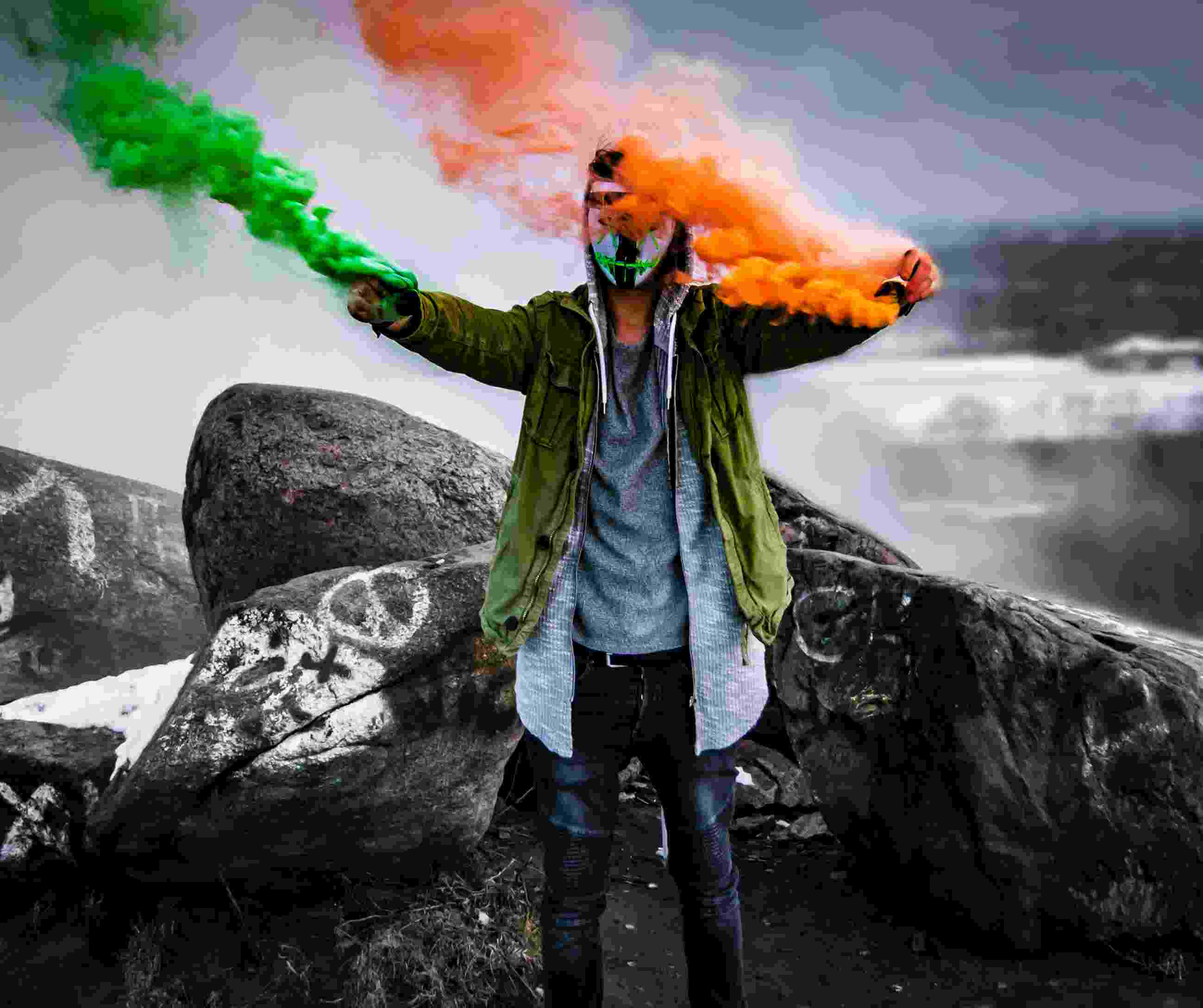 An Irish football fan with green and orange flares